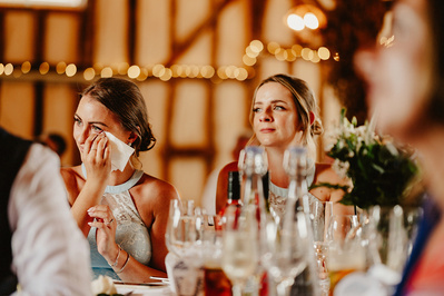 a bridesmaid sheds a tear at winters barns during the wedding speeches