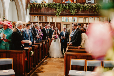 Bride and her father walking down the aisle in a Kent Church