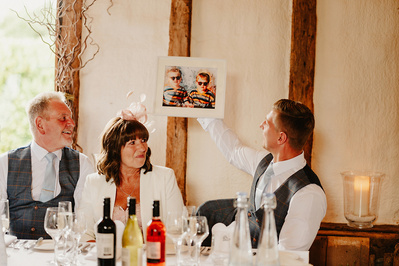 winters barns speeches with best man holding up amusing photo of him and the groom