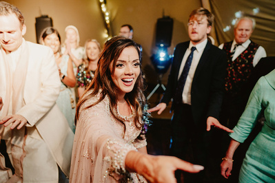Kent Bride holding out her hand on the dancefloor during kent wedding reception