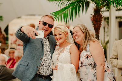 Wedding reception guests taking a photo together at Marleybrook House