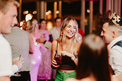 candid photo of a woman having a great time on the night yards dance floor during the evening reception