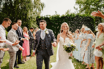 bride and groom laughing during confetti photograph at winters barns