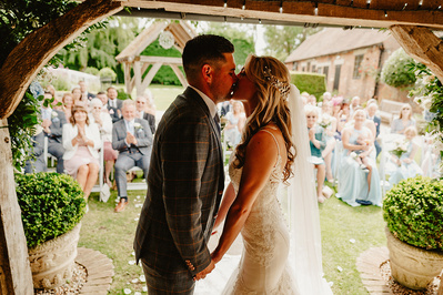 first kiss in the outdoor ceremony area at winters barns