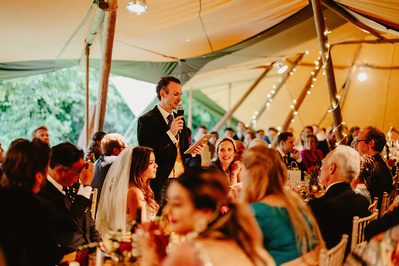 Groom doing his speech during wedding reception in the garden at Kent