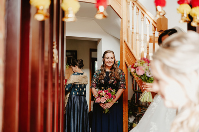 Bridesmaid smiles through a door
