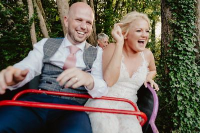 Bride and groom racing on the rollercoaster at Marleybrook House