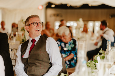 Wedding guest laughing during speeches at marleybrook house