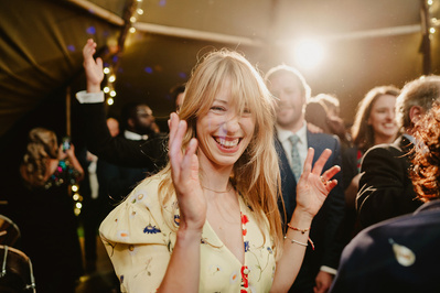 Colour photo of wedding guest clapping to Music on the dancefloor