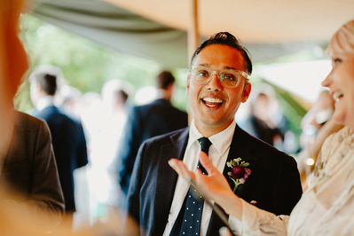 Candid photo of a man smiling during Kent garden wedding
