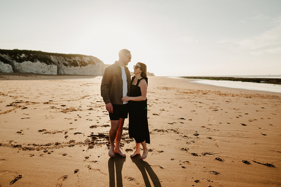 Man and woman embracing during a romantic sunset at botany Bay