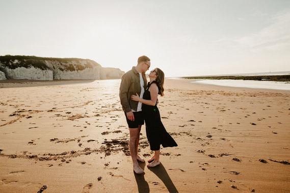 Botany Bay sunset couple looking each other in the eyes while having a lovely hug on the beach during sunset