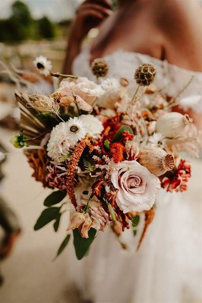 beautiful dried florals being held by a bride