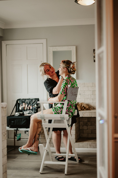 Bride on her wedding day, having make up applied at the blazing donkey