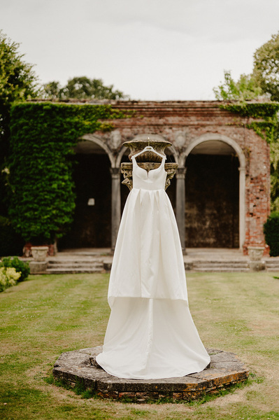 White wedding dress in the Italian gardens at Broome Park Hotel