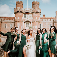 bridesmaids having fun for a photo outside a kent castle on wedding day