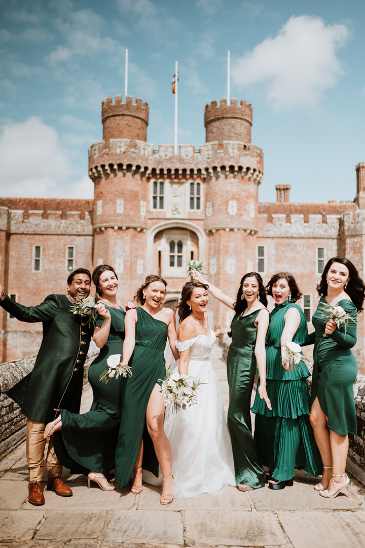 bridesmaids having fun for a photo outside a kent castle on wedding day