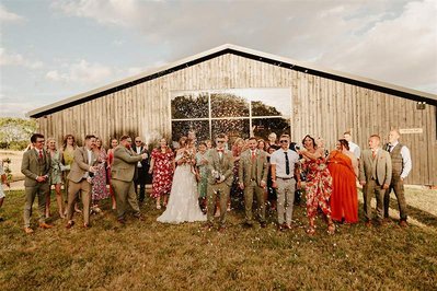 champagne spray chaos with the wedding guests and bridal party at silchester farm