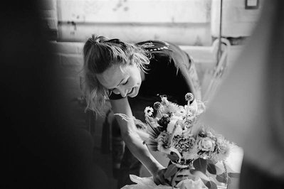 black and white photo of a florist setting up flowers at silchester farm