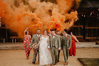 bridal party at silchester farm in a fun smoke bomb portrait 