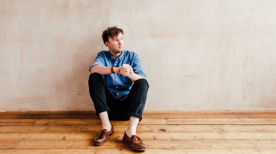 james pearce sitting down for a branding portrait as a kent wedding photographer who strives to give his madly in love couples the best wedding photography
