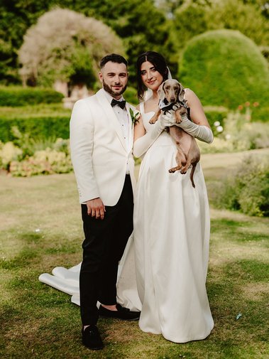 bride and groom at broome park wedding venue with their sausage dog during wedding photography portraits