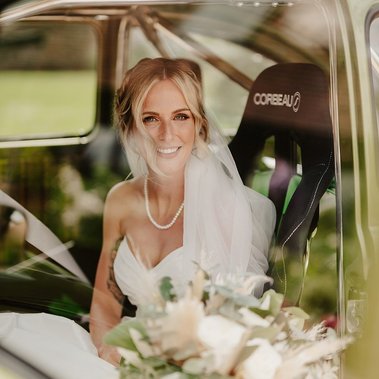 bridal portrait in a custom VW car at the old kent barn taken through a window reflection