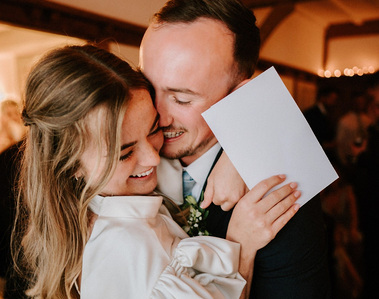 groom embracing his new wife during her surprise wedding speech in kent