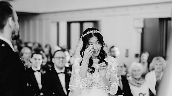 A heartfelt moment captured as a bride sheds a tender tear during a relaxed and intimate wedding ceremony.