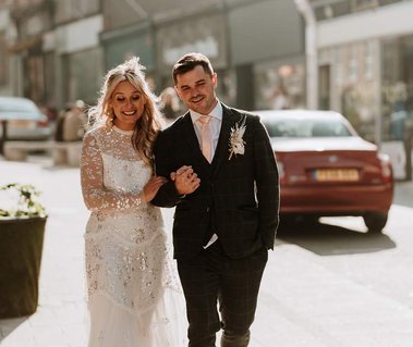 Bride and groom walking with their wedding photographer from the Sands Hotel in Margate on the amazing Kent wedding day 
