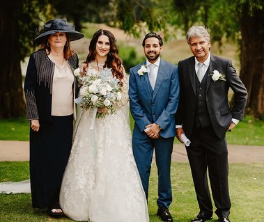 wedding photo of bride and groom standing in a formal traditional wedding photo at the kent venue the orangery in maidstone in natural light