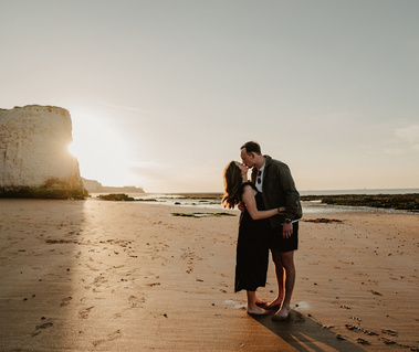Couple having emotional kiss on botany Bay in front of the chalk stacks