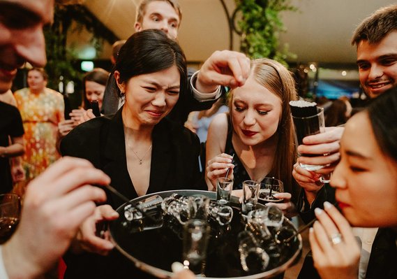 wedding guests in kent drink sambuca of a drinks tray on dance floor