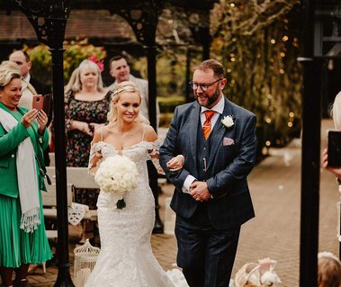 One of the best wedding venues in Kent the Oakham born a bride and her father Bing walks down the aisle before the wedding ceremony