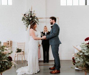 The amazing kent wedding venue winding house in Dover with its natural light filled ceremony room bride and groom staring at each other lovingly