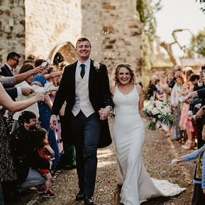 fun confetti photo of the bride and groom exciting a church in kent
