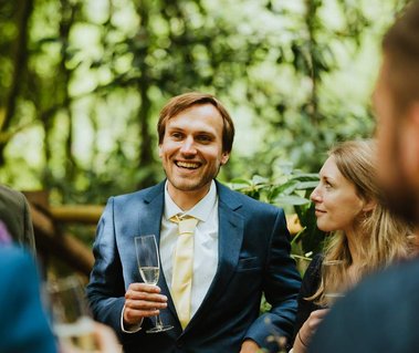 Woman lovingly gazes at her partner who is laughing at the unique Woodlands kent wedding venue papermill