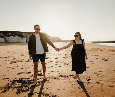 Kent engagement shoot at the beautiful botany Bay in Broadstairs couple walking on the beach holding hands