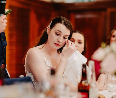 Emotional bride wipes away her tears during special wedding speeches at Pelham house