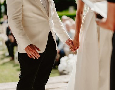 bride and groom holding hands during an outside wedding ceremony at the broome park hotel wedding venue in kent