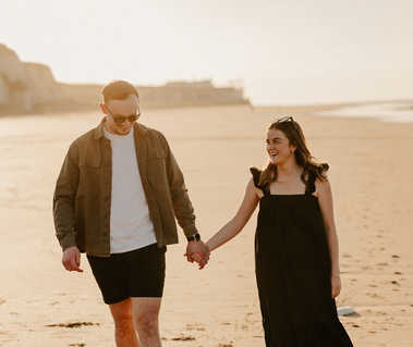 Engaged couple walking along botany Bay during golden hour Broadstairs