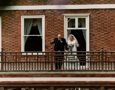 bride and groom on the balcony at commissioners house at the chatham dockyard for their wedding day