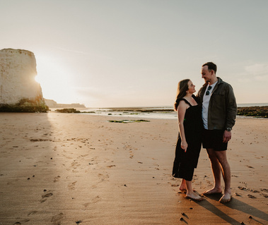 couple pose for photo in front of the famous botany bay chalk stacks