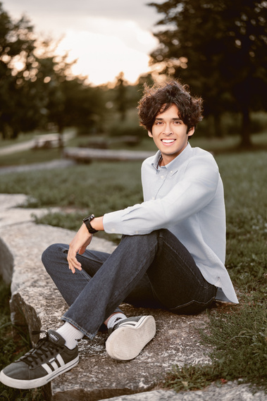 A high school boy's senior portrait featuring a stunning sunset in Mequon, Wisconsin. The serene ambiance and the beautiful evening light make this photo a perfect representation of senior year. 