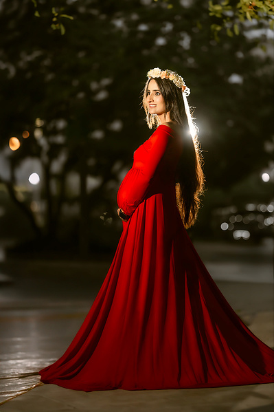Beautiful outdoor maternity photoshoot in Mequon Wisconsin, featuring a pregnant woman in a red dress. Capturing the serene and joyful moments of pregnancy in nature. 