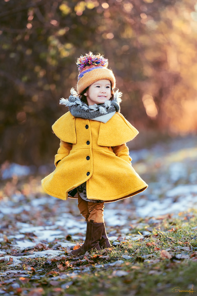 A beautiful outdoor portrait of a girl in yellow coat. Picture was taken in Cedarburg Wisconsin. 