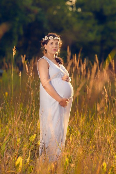 Elegant outdoor maternity session in Mequon, Wisconsin, featuring an expectant mother in a beautiful dress. Capturing the special moments of pregnancy in a picturesque natural setting. 