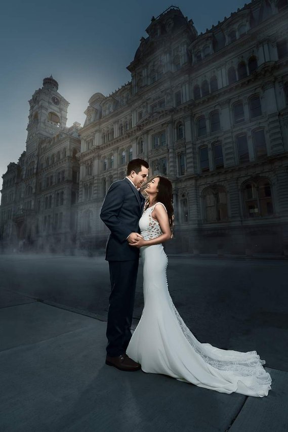 Splendid portrait of Bride and groom in downtown Milwaukee during the blue hour. Epic scenic background of an old architecture. 