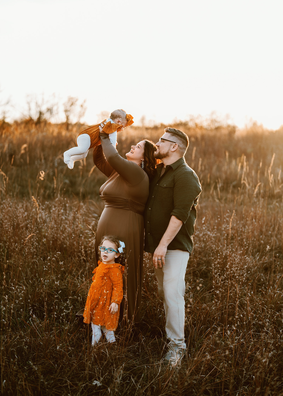 Outdoor family photography, beautiful sunset lighting in the field of Wisconsin. 