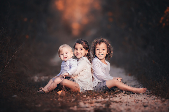Joyful expression of three siblings, amazing outdoor portraits of children at Riveredge Nature Center Saukville WI. Beautiful family photograph. 